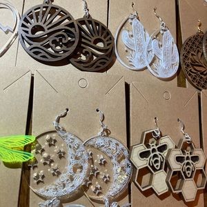 Laser cut earrings in various acrylic colors or walnut, cherry, or basswood.
